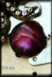 Steampunk pendant featuring Cthulhu and pink paua abalone shell