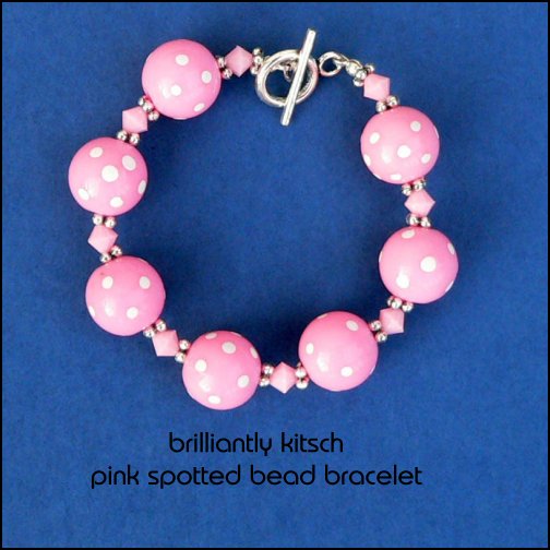 bracelet made with pink plastic spotted beads and pink plastic bicone beads, fittings are Tibetan silver