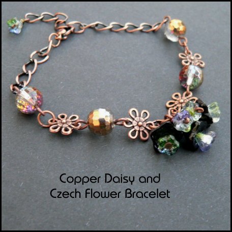 a pretty  black czech glass bell flower cluster is the centrepiece of this bracelet linked by copper daisy connectors and golden faceted czech glass beads 
