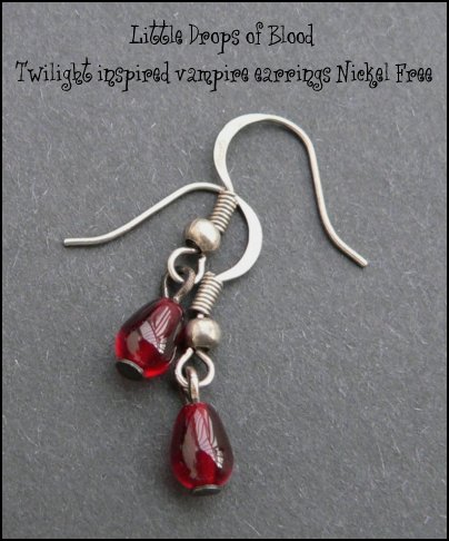 Richly glowing blood red claret glass drops trembling from silver ox earwires.