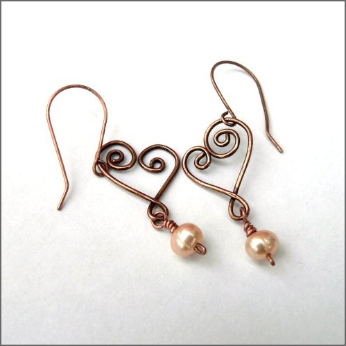 Freshwater pearl and copper heart earrings. Handforged copper hearts each embellished with a beautiful pale honey coloured freshwater pearl