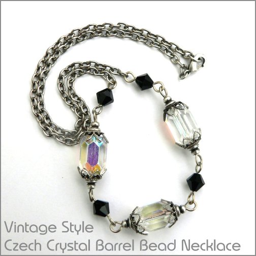 Beautiful iridescent crystal glass beads ornamented with delicate lacey filigree beadcaps and complemented by jet black swarovski crystals make this a stuning necklace